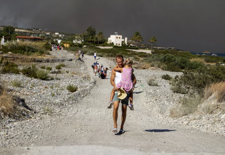 Greek authorities evacuate some 19,000 people as wildfire blazes on the island of Rhodes